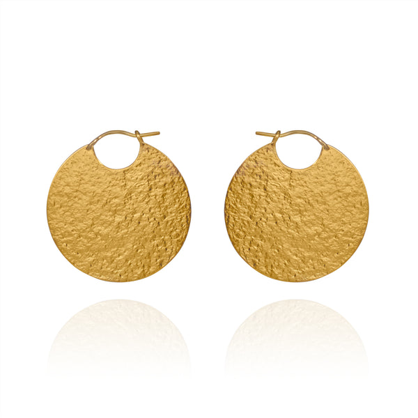 Large gold disc hoop style earrings with textured finish.