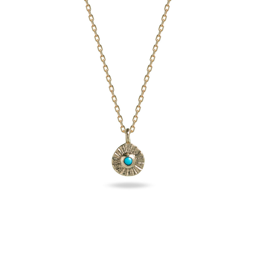 small gold pendant with turquoise stone and stamped line detail on gold chain at IndependentBoutique.com