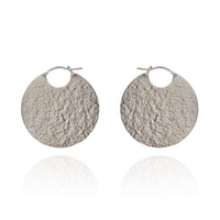 Large silver disc hoop textured earrings.
