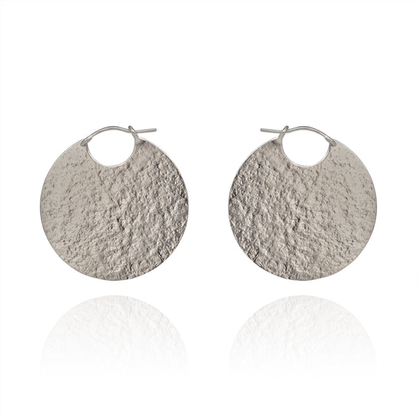 Large silver disc hoop textured earrings.