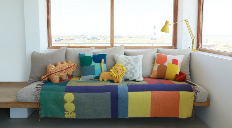 photo of sofa with lots of novelty knitted cushions from Donna Wilson 