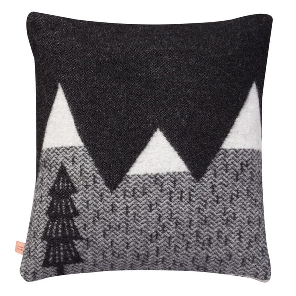 back view of black and white woven cushion with mountain scene from donna wilson