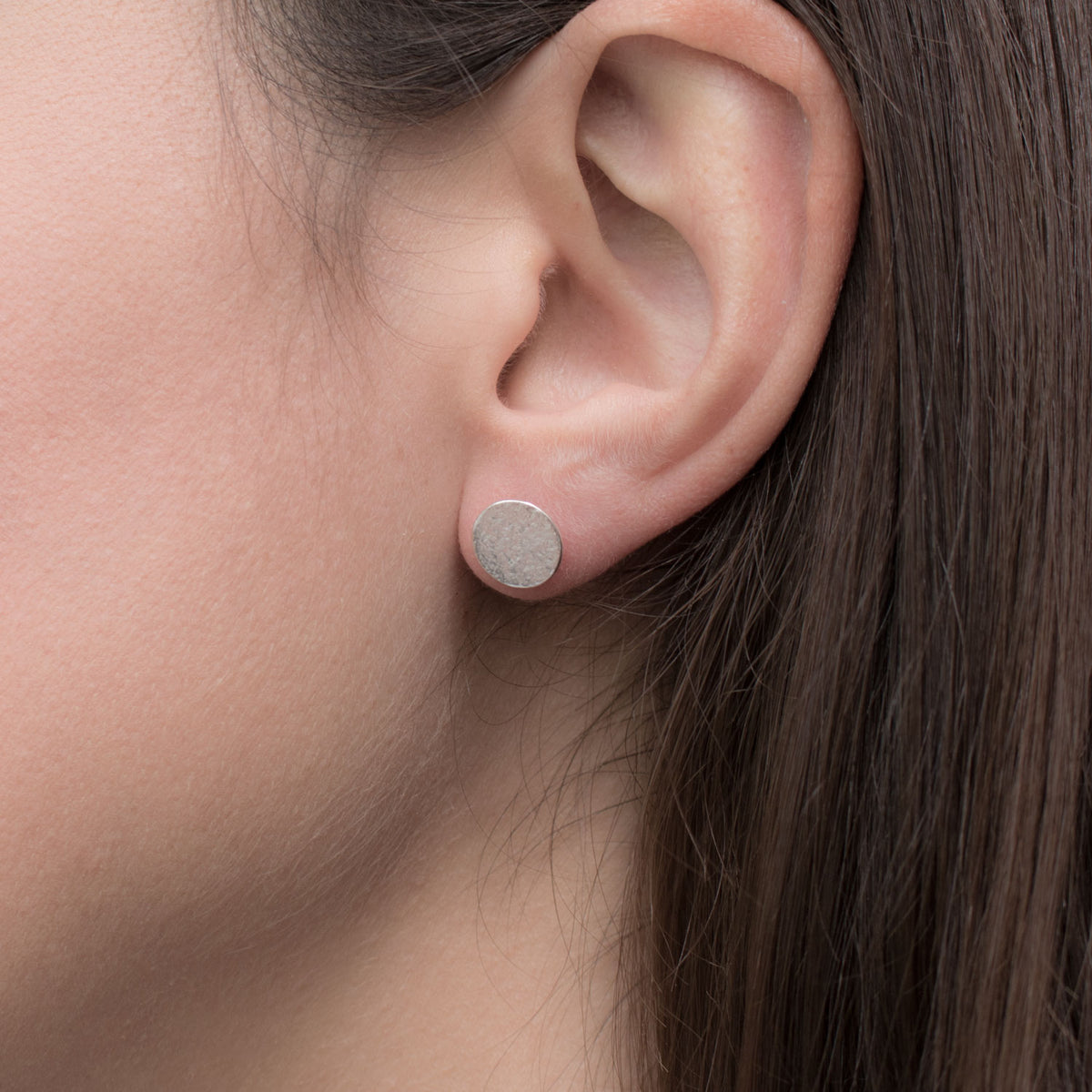 Silver medium size stud earrings on model