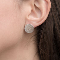 Silver large stud earrings on model