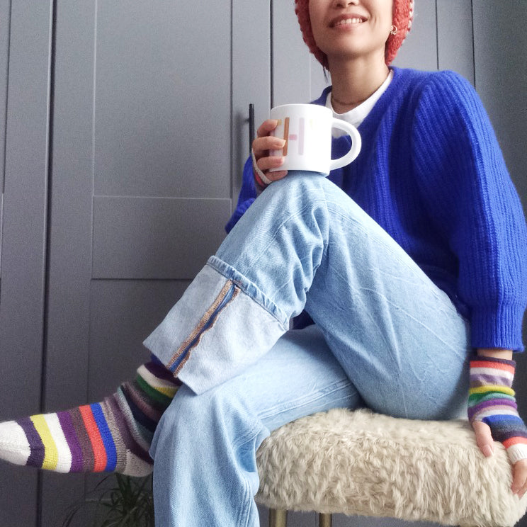 model wearing multicolour cashmere socks and handwarmers cropped