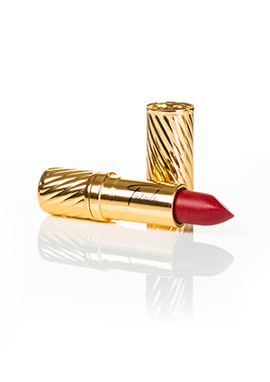 red lipstick in gold embossed tube with black Fatale logo on side at IndependentBoutique.com