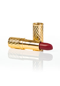 red lipstick in gold embossed tube with black Fatale logo on side at IndependentBoutique.com