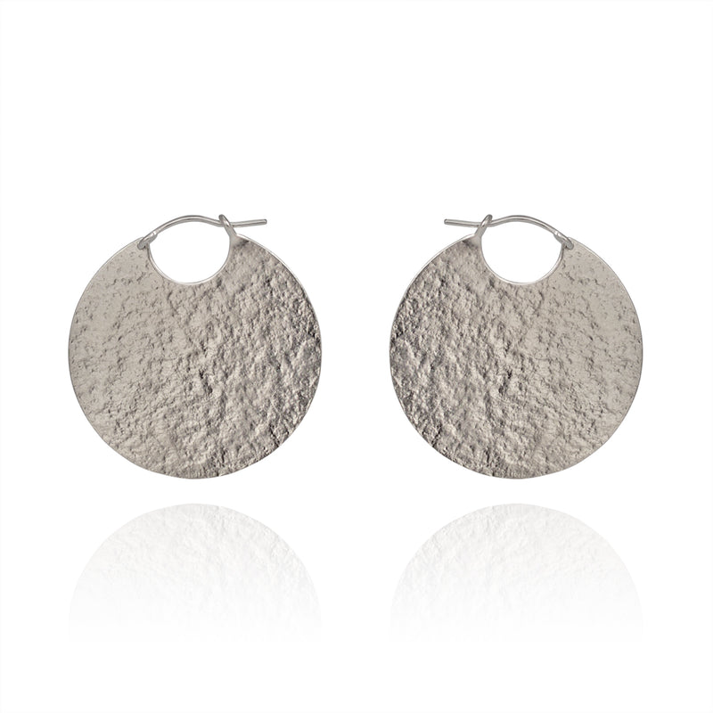 Large silver disc hoop textured earrings.